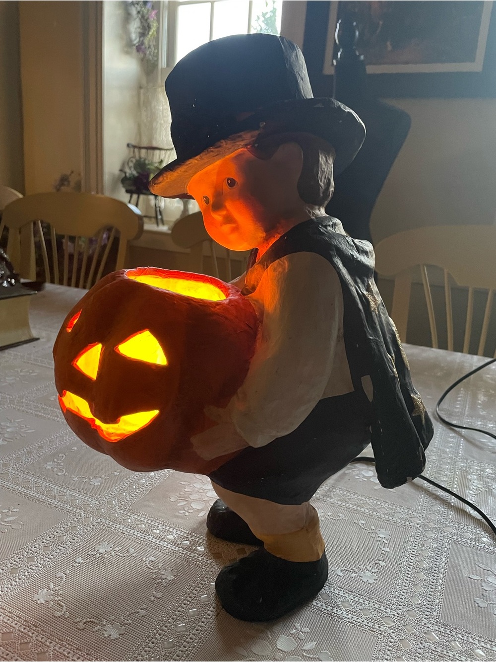 Halloween decoration that lights up ,it’s a little boy holding a pumpkin-